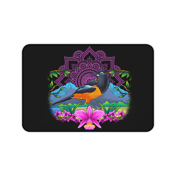 A desk mat with a colorful floral and bird design on a black background.