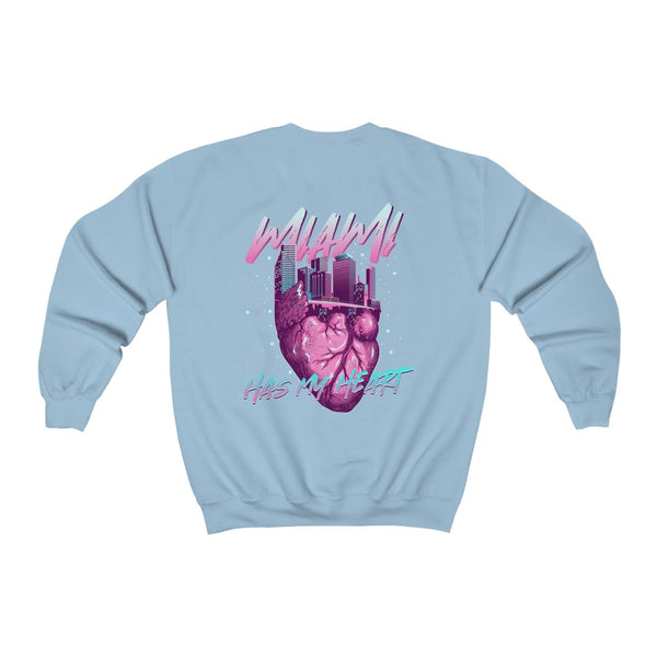 This women's sweatshirt features a unique design inspired by the vibrant Miami skyline, cleverly shaped into a heart. The phrase "Miami has my Heart" is prominently displayed, embodying the spirit of the city. The color scheme utilizes Miami Vice baby blue and hot pink, giving it a fun and trendy vibe that captures the essence of Miami's lively atmosphere. It's a perfect piece for those who want to showcase their love for this iconic city!