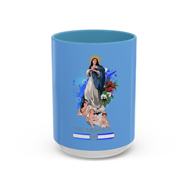 Taza de café de cerámica azul con diseño de flores tropicales y una ilustración de la Virgen María con un niño, con la inscripción 'NICARAGUA' en la parte inferior.