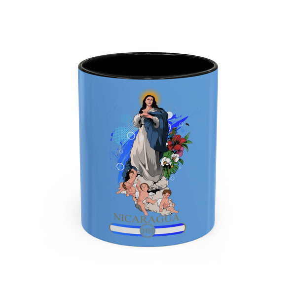 A blue ceramic coffee mug with a colorful floral design and an illustration of the Virgin Mary holding a child, with the name 'NICARAGUA' printed across the bottom.