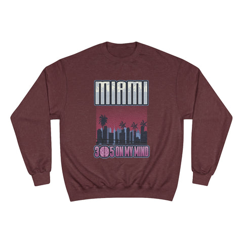 The Miami sweatshirt showcases a vibrant design of the iconic Miami skyline. The word "Miami" is boldly displayed at the top, while the number "305" is featured at the bottom. A unique twist is that the "0" in "305" is creatively replaced with a brain, symbolizing the phrase "305 on my mind." This stylish piece is perfect for those who want to express their love for the city and its culture.